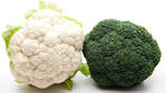 a head of white cauliflower and a head of bright green broccoli
