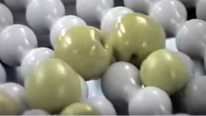 White urethane rounded spools on a Speed Sizer with green apples