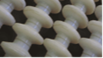 White v-shaped spools on a Kerian Sizer designed to sort flat produce